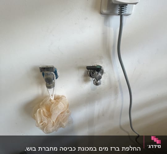 שני ברזים על קיר עם צינור מחובר